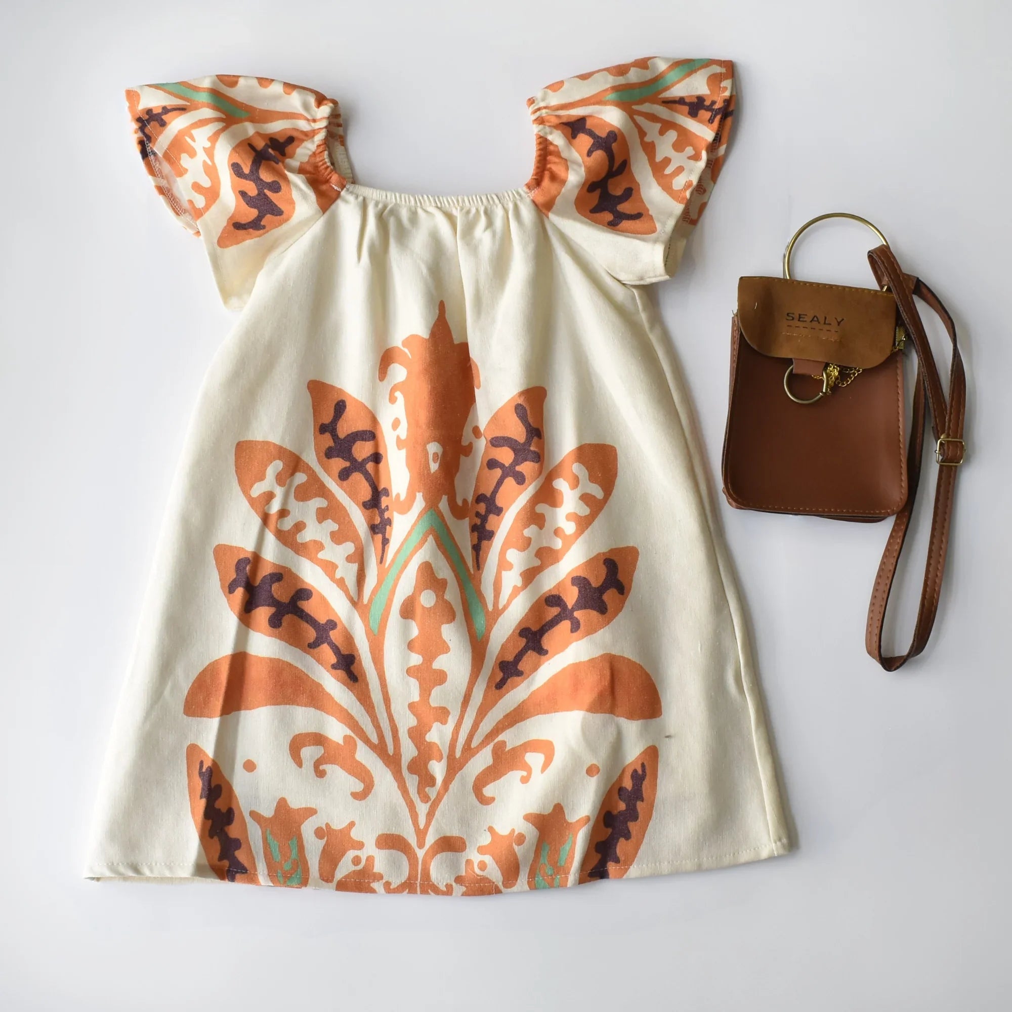 Tropical Isla Girls Linen Dress featuring vibrant floral print and puffed sleeves, perfect for summer outings.