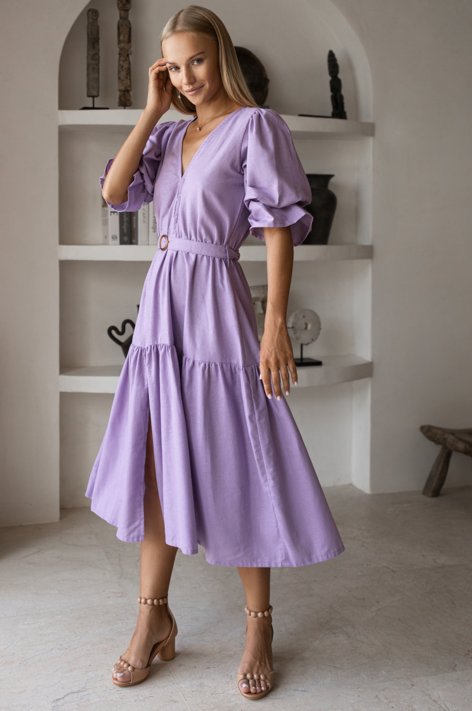 Peony Midi Dress (Sale) in soft linen, featuring a V-neckline and gathered puff sleeves, styled in a beautiful purple color.