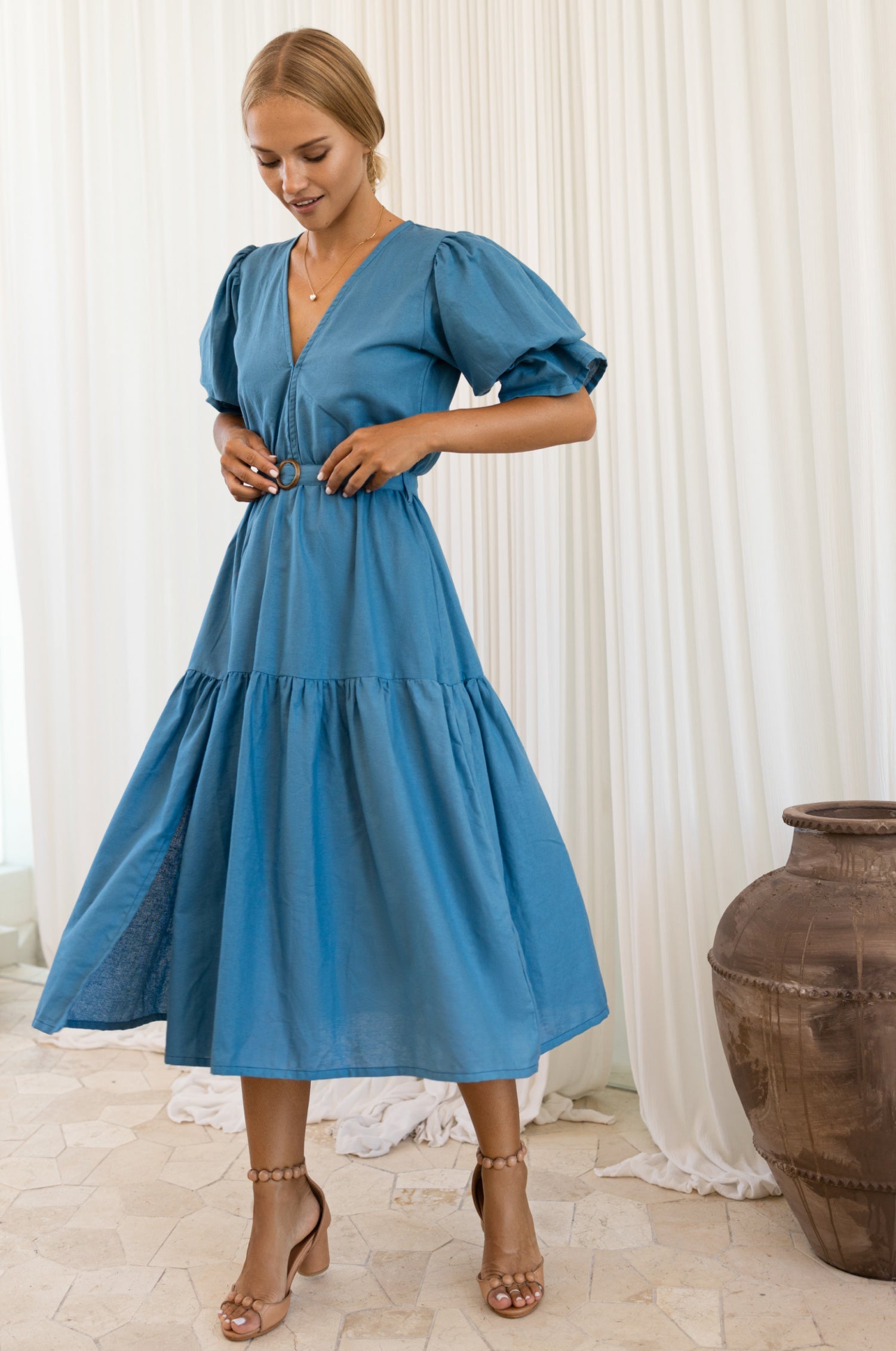 Model wearing the Peony Midi Dress (Sale) with gathered puff sleeves and matching linen belt.