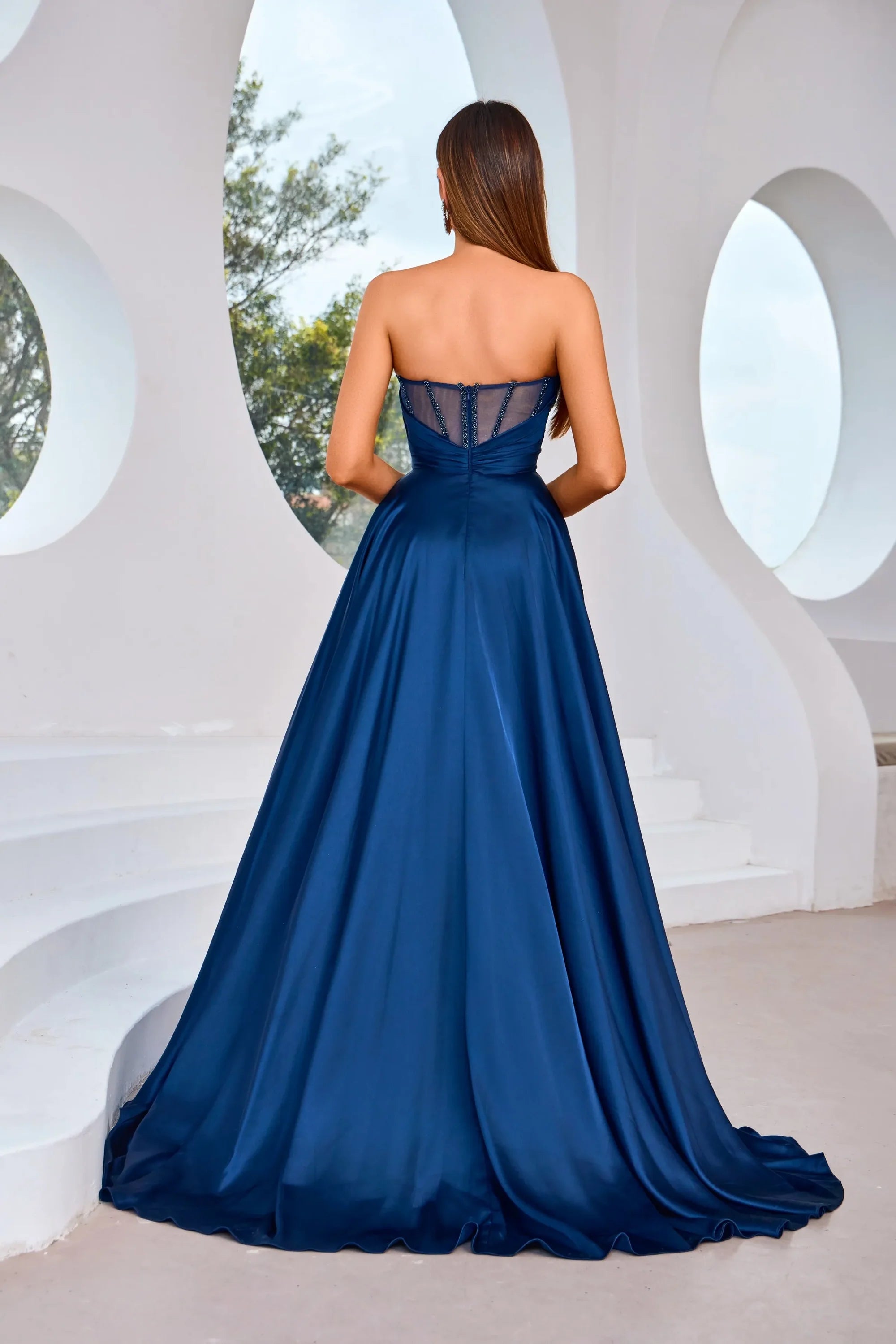 Stunning back view of the J25007 dress featuring a strapless design and elegant navy hue.