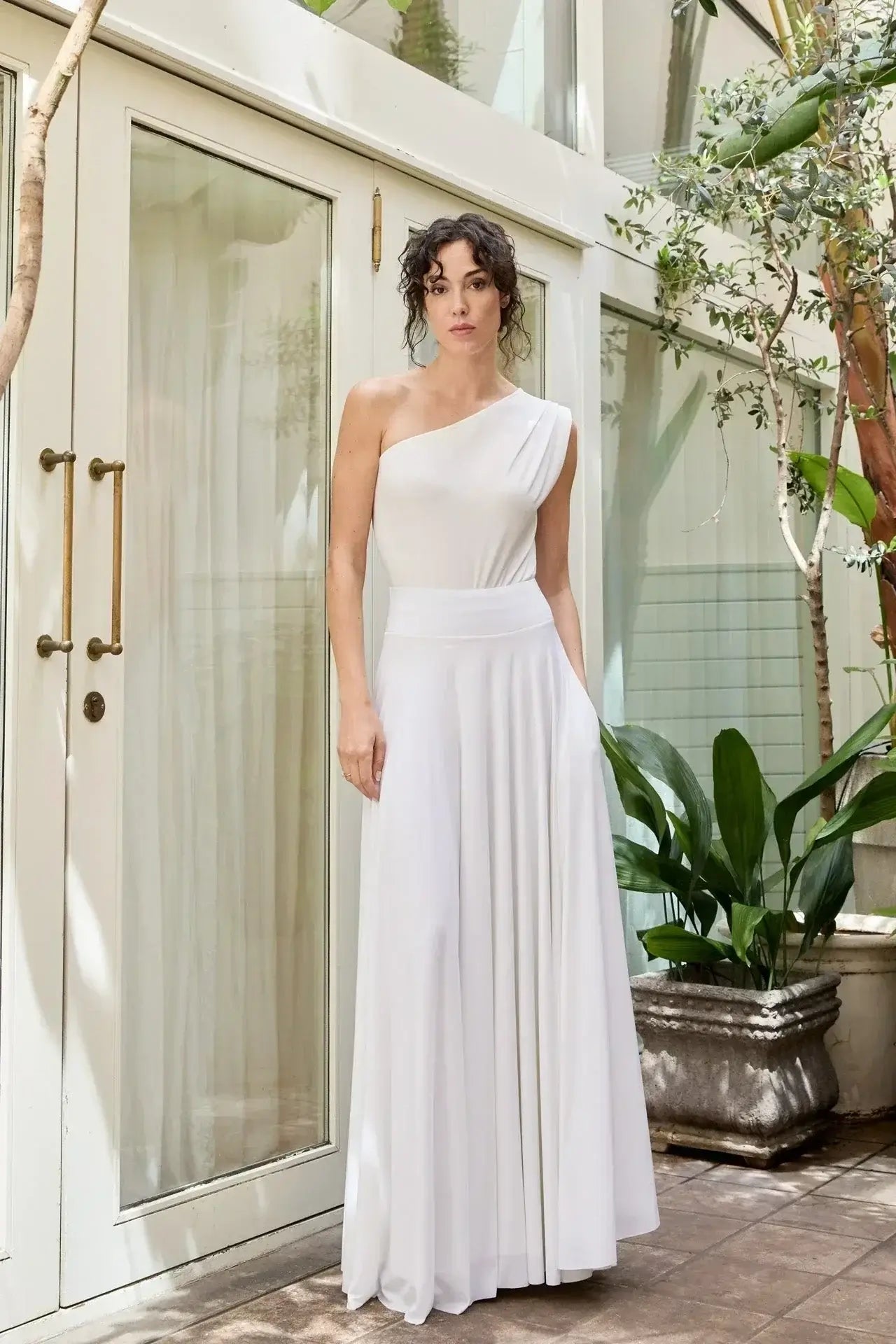 Elegant woman in a white dress showcasing the latest in woman&