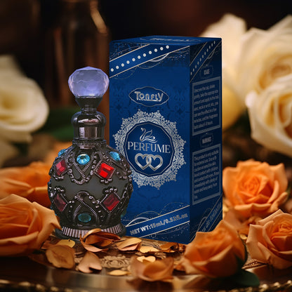 Enchanted Arabian Dreams Essential Oil Perfume in ornate bottle with blue packaging surrounded by roses.