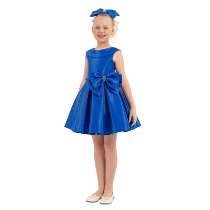 Girls formal satin dress Stellar Satin Girls Formal Dress on a young girl, featuring a big bow, shiny satin fabric, and a playful design.
