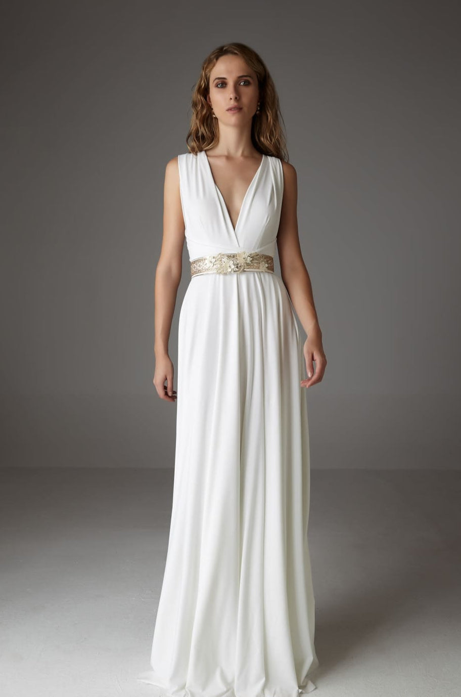 Model wearing INFINITY MAXI DRESS BRIDE, a versatile long wedding dress with elegant design and gold belt.
