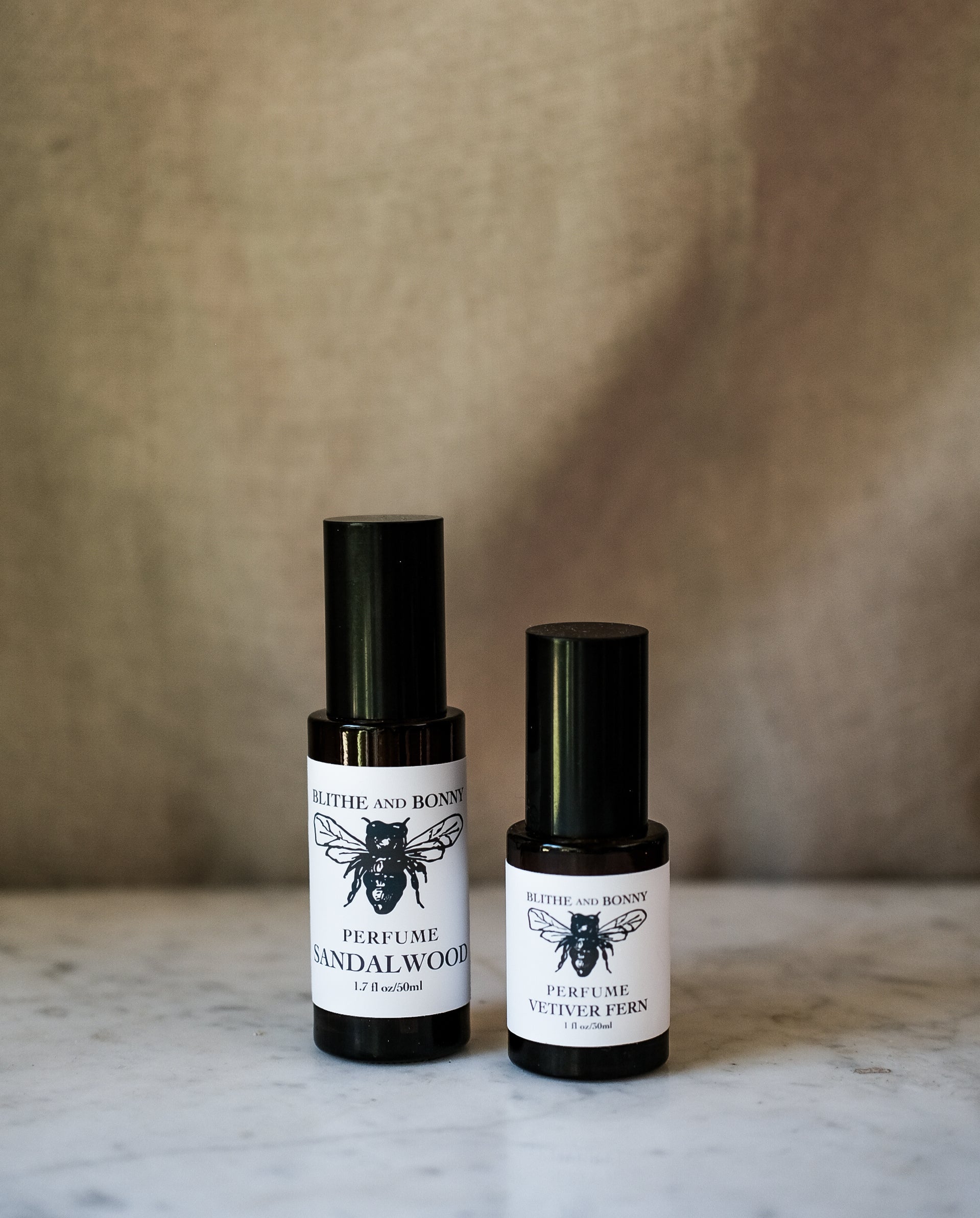 Petite Perfume bottles, including Sandalwood and Vetiver Fern, showcasing phthalate-free scents in stylish packaging.