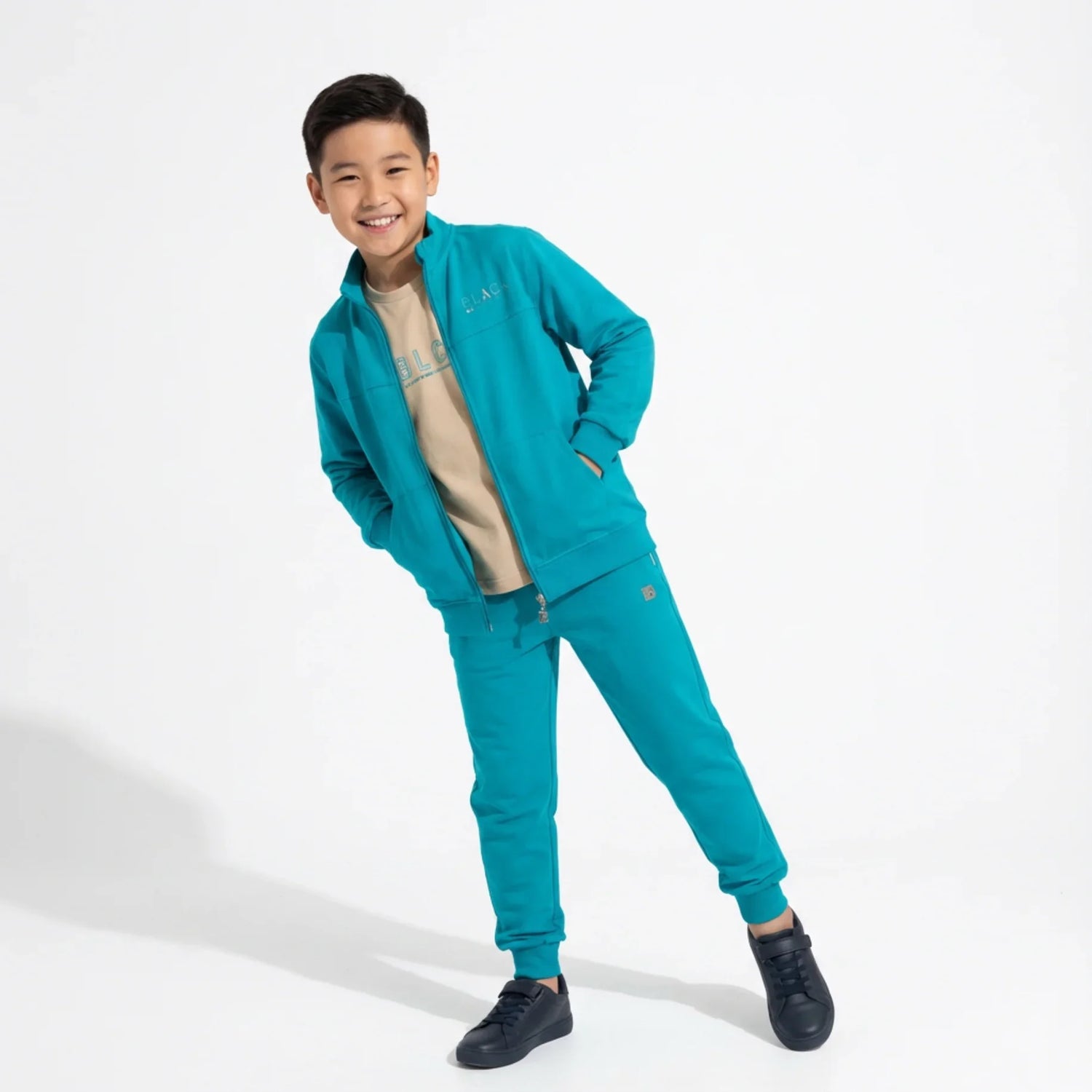 Zip-Up Tracksuit Unisex Casual Set on a young boy wearing a teal zip-up jacket and matching jogger pants.