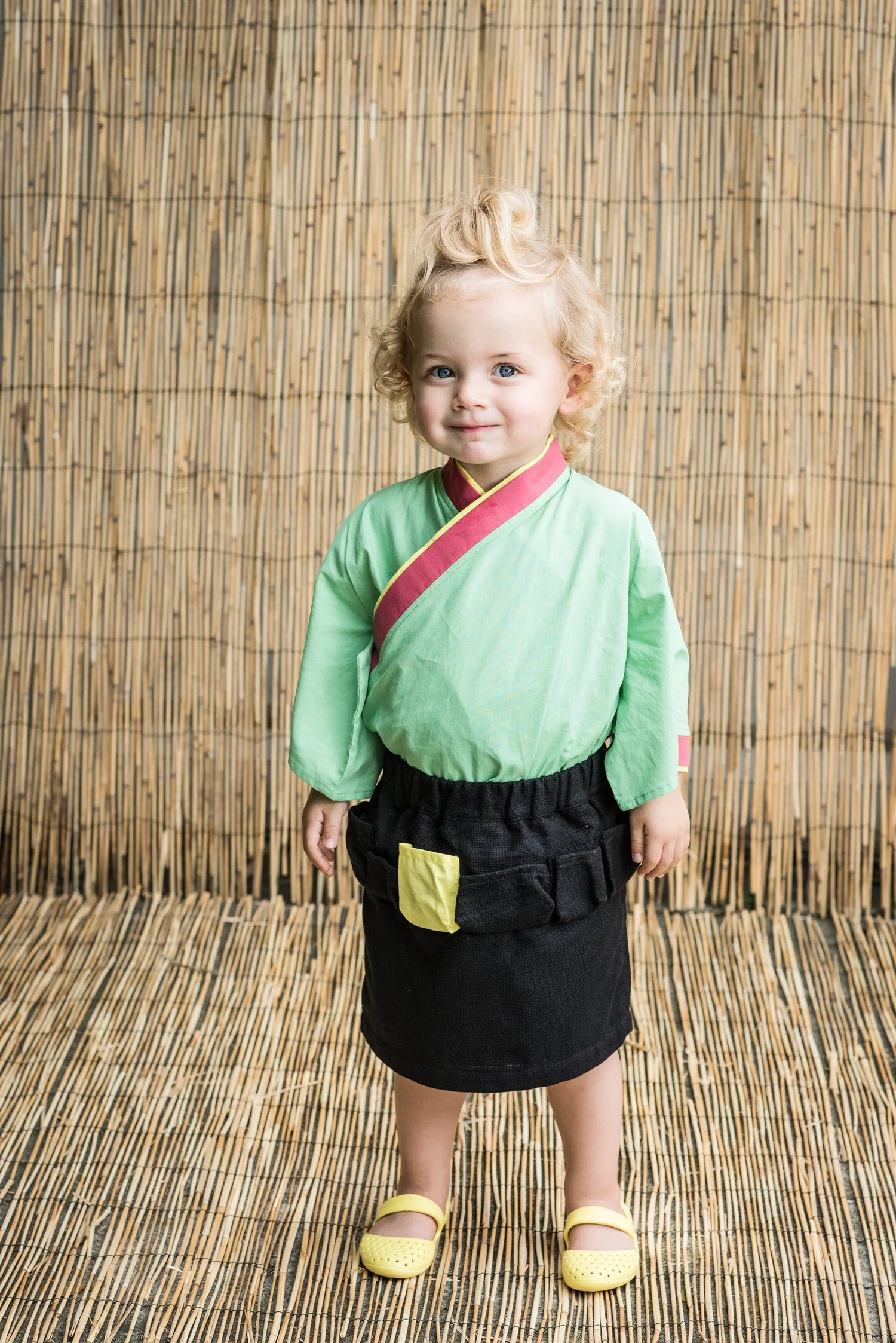 Cute girl wearing a green top and black Girls&