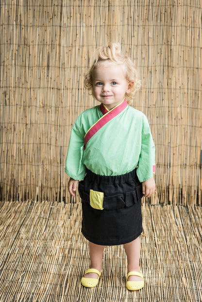 Cute girl wearing a green top and black Girls&