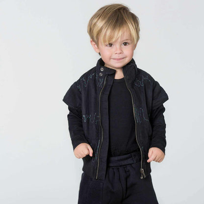 Kids embroidered vest with skyline embroidery worn by a smiling child, showcasing warmth and unique design.