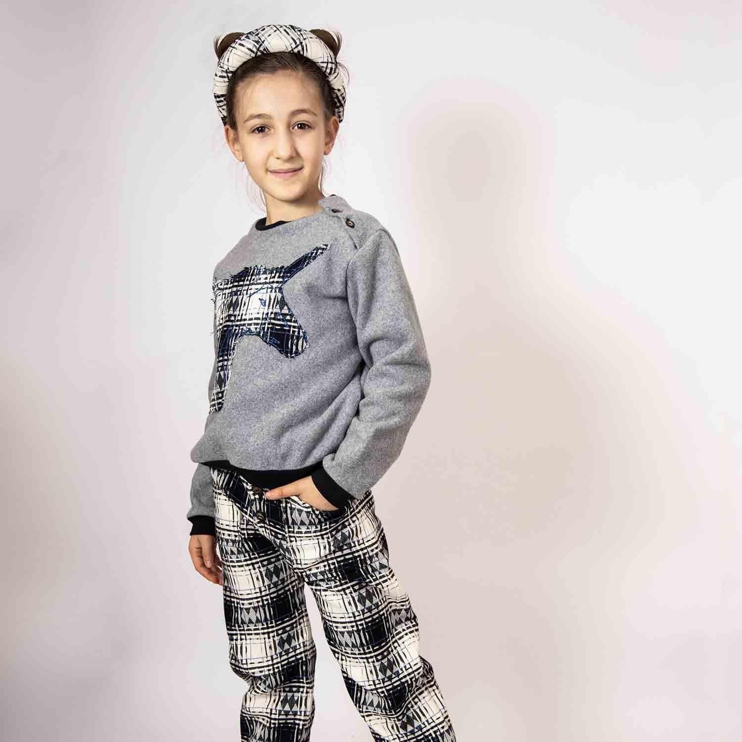 Kids Pants in Black &amp; White Tartan, styled with a matching top and headband, showcasing a classic tartan pattern.