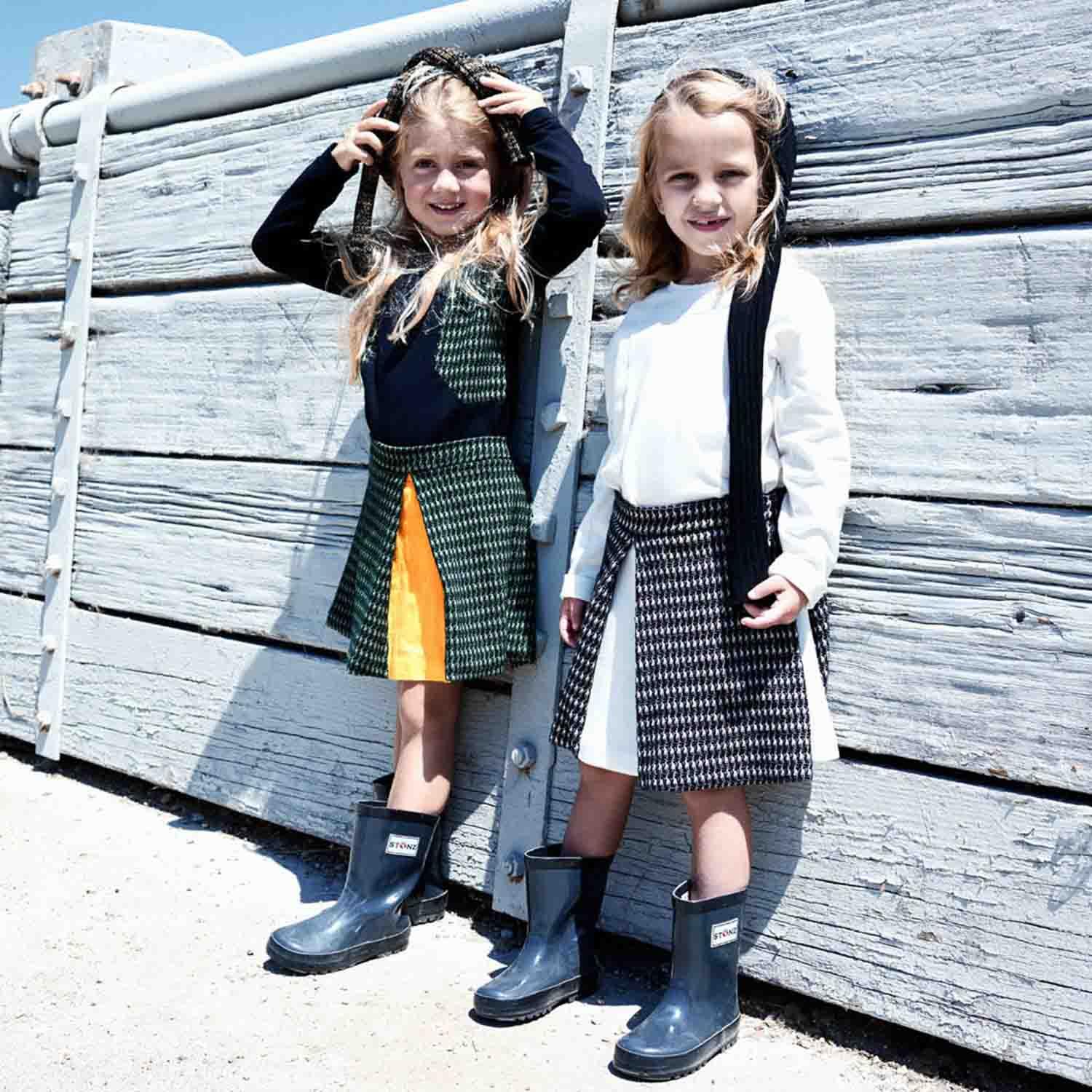 Mini Circle Skirt inBlack and White worn by two girls with rain boots, showcasing stylish children&