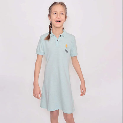 Mint Green Girls Polo Dress on a girl smiling, showcasing the soft fabric and playful design.