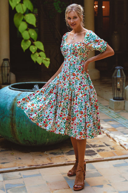 Lilit Midi Dress in floral design, featuring puff sleeves and gathered front detailing, perfect for casual outings.