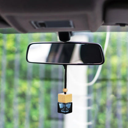 Hanging car perfume diffuser seen from inside a vehicle, enhancing the car&