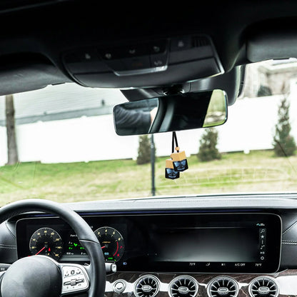 Hanging car perfume diffuser in an elegant car interior, enhancing ambiance and freshness.