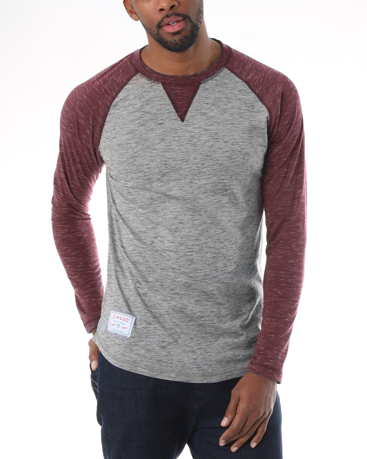 ZIMEGO Men Athletic Fit Baseball Retro Contrast Long Sleeve Raglan T-Shirt modeled by a man in a two-tone gray and maroon color.