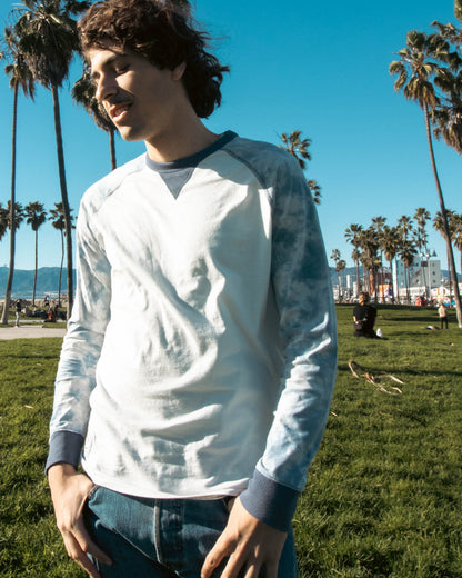 Mens Long Sleeve Tie Dye Modern Fit Stretch Contrast Raglan Casual Crew Neck T-Shirts in a sunny park setting.