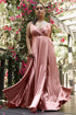 A model wears a Flowy Satin A-Line Gown in blush pink, set against a backdrop of vibrant flowers.