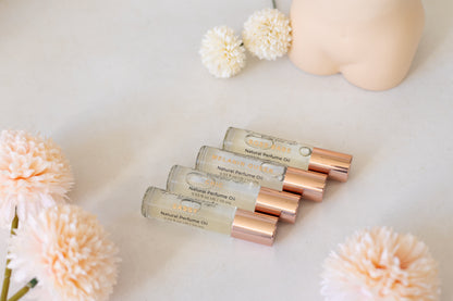 For Her" Perfume Oil Roll-On displayed with floral ambiance for chic and sassy women.