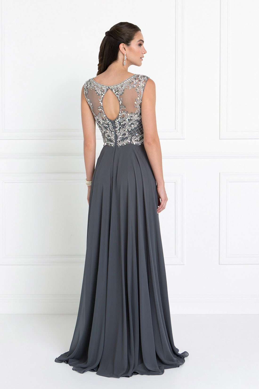 Back view of a model wearing a Chiffon Sweetheart A-Line prom dress in Charcoal with a Cut-Out Back detail.
