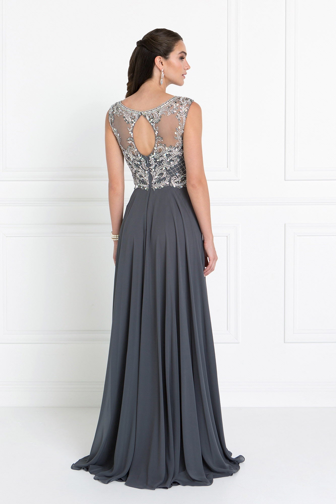 Back view of a model wearing a Chiffon Sweetheart A-Line prom dress in Charcoal with a Cut-Out Back detail.
