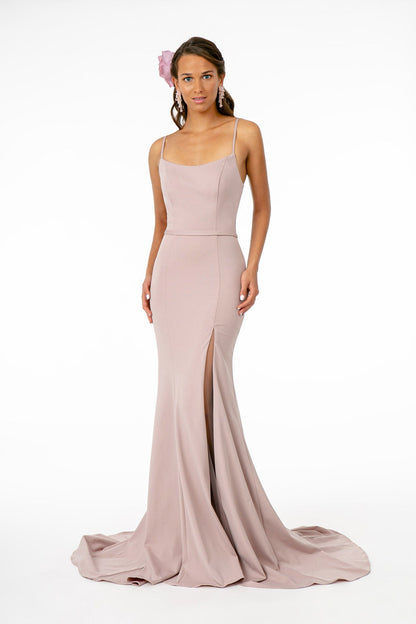 Model wearing Rome Jersey Illusion Side Slit Long Dress in mauve with spaghetti straps and open back.