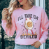 A woman wearing a pink sweatshirt featuring the graphic "I&