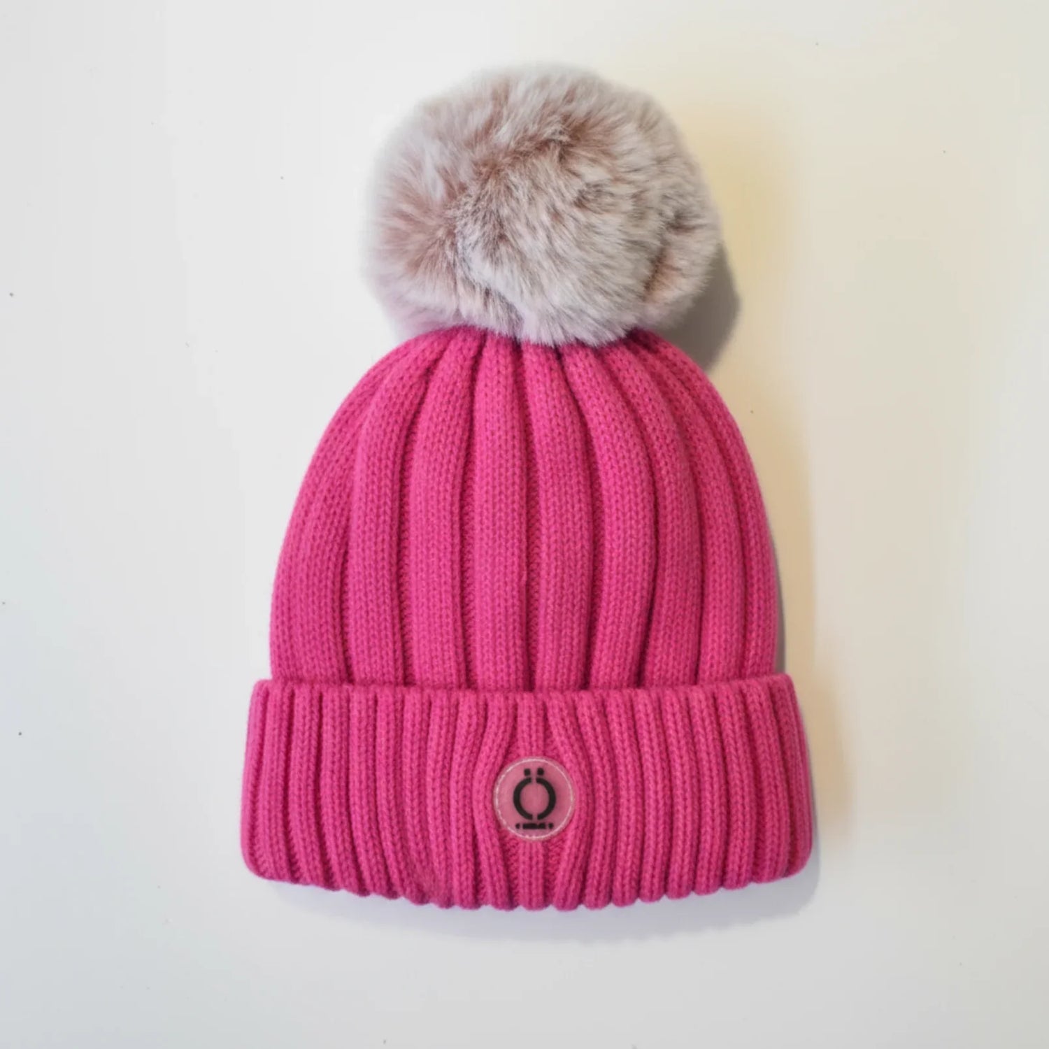 Fushia Tuque with removable fur pompom and soft polar fleece lining, perfect for style and warmth.
