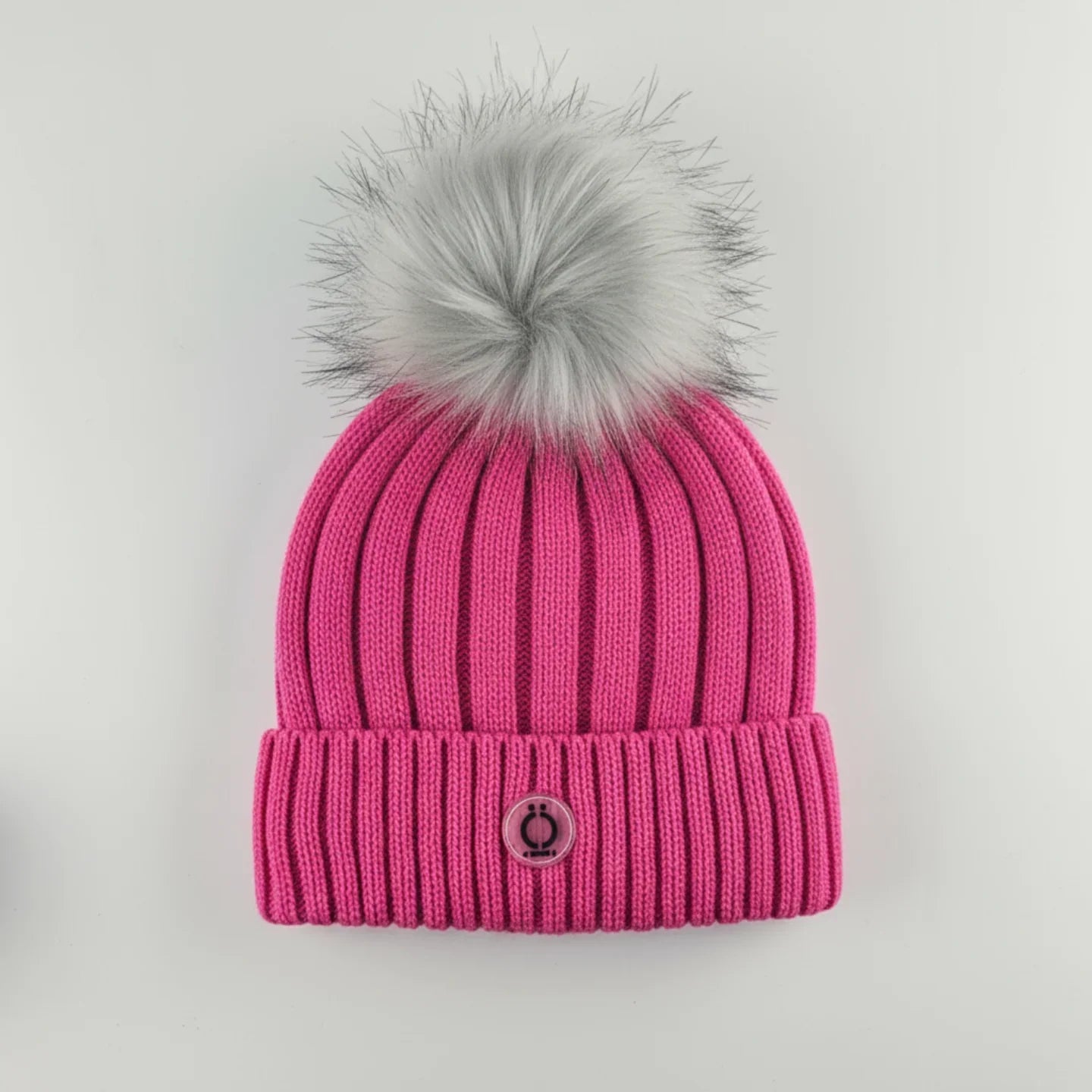 Fushia Tuque with soft gray fur pompom and ribbed design, featuring a polar fleece lining for warmth.