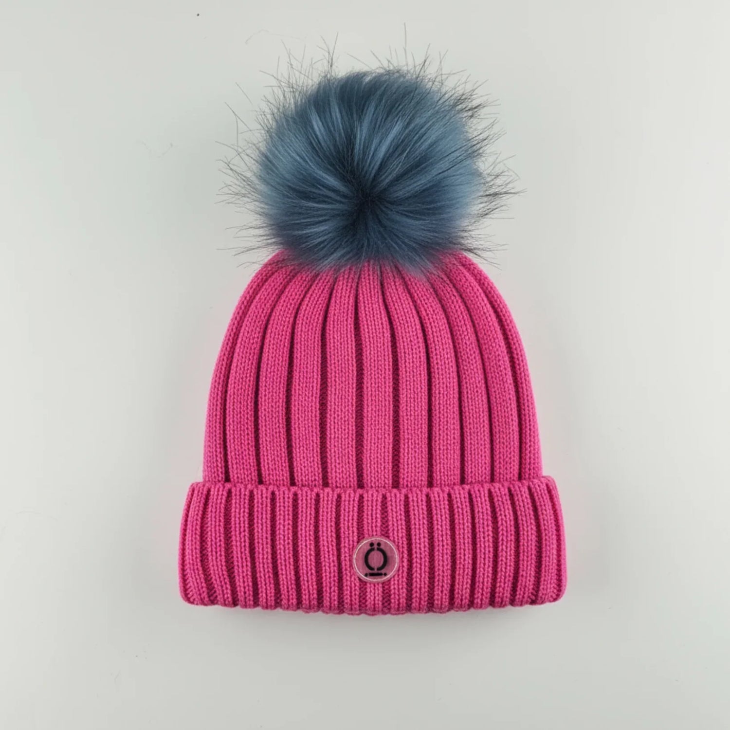 Fushia Tuque with removable blue fur pompom and ribbed design, 100% acrylic and polar fleece lining.