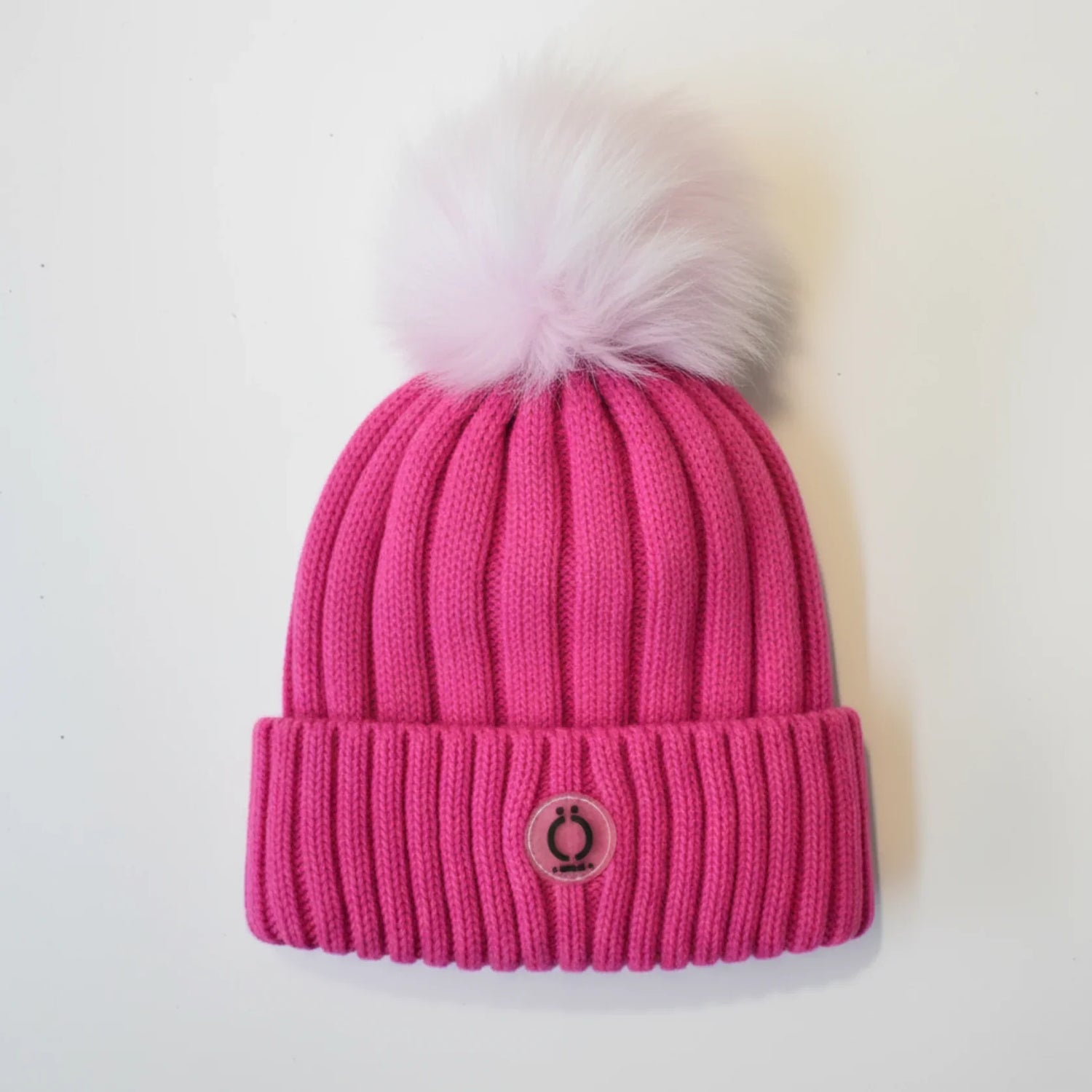 Fushia Tuque knit hat with removable soft pink pompom and ribbed design.