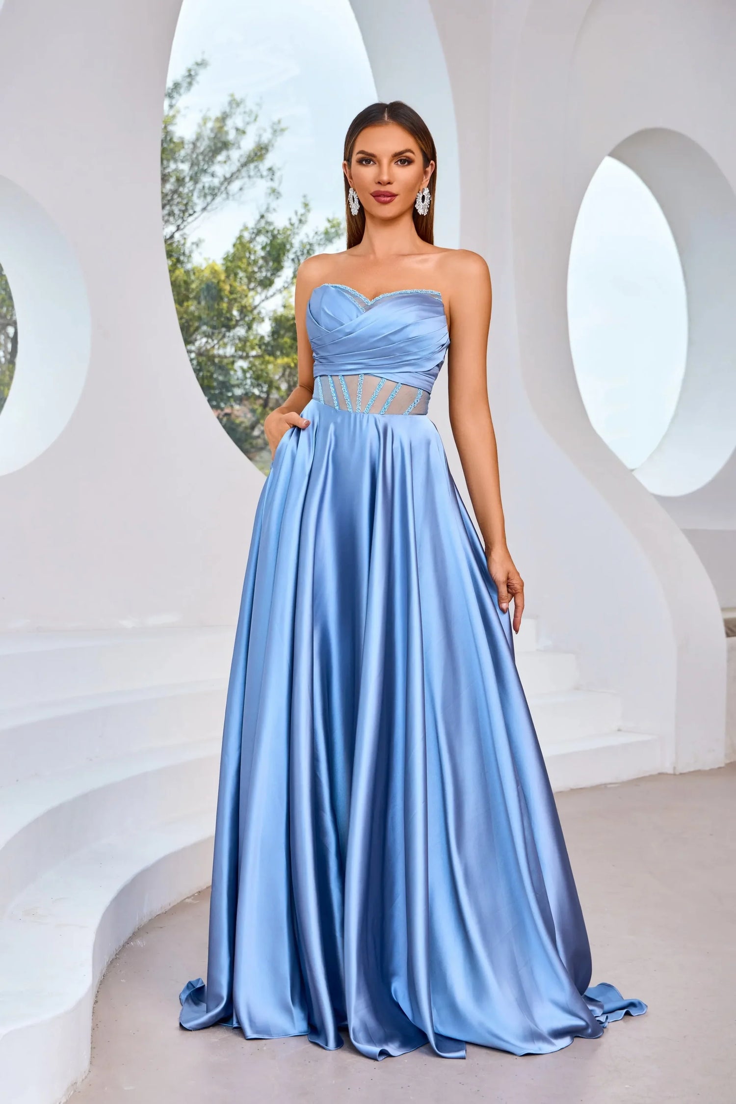Elegant J25007 strapless dress in powder blue, featuring an illusion sweetheart neckline and flowing A-line silhouette.