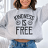 Woman wearing a cozy sweatshirt featuring the text &