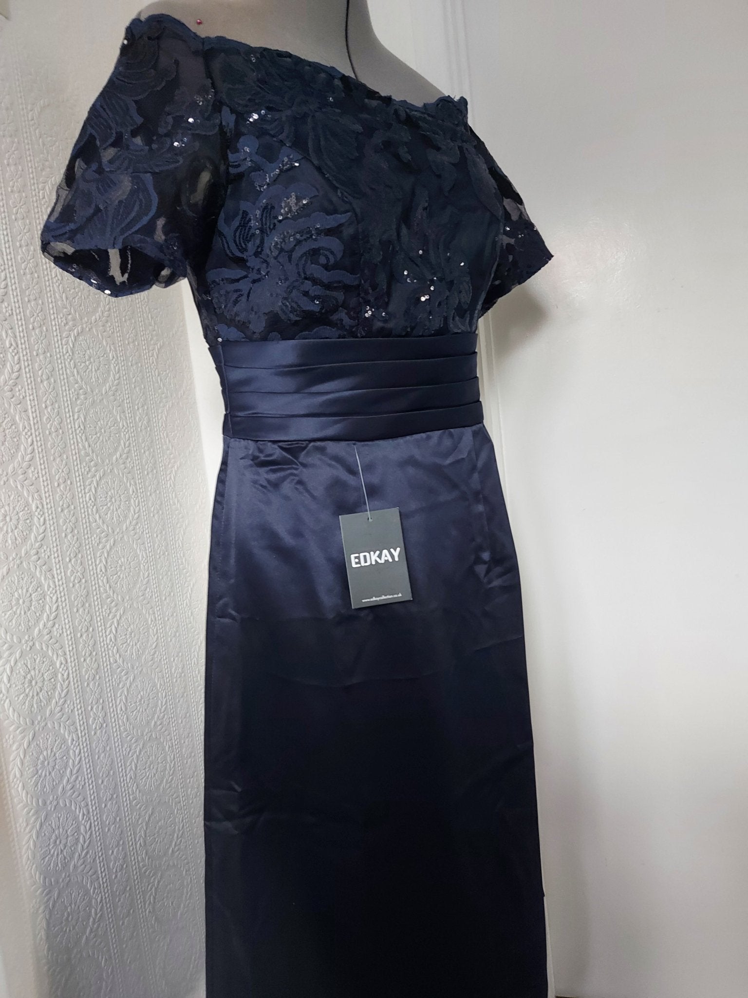 Navy blue lace appliqued knee length bridal dress featuring cap sleeves and satin fabric.