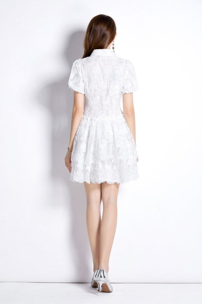 Back view of a model wearing a White Embroidered Puff Sleeve French Dress with delicate lace details.