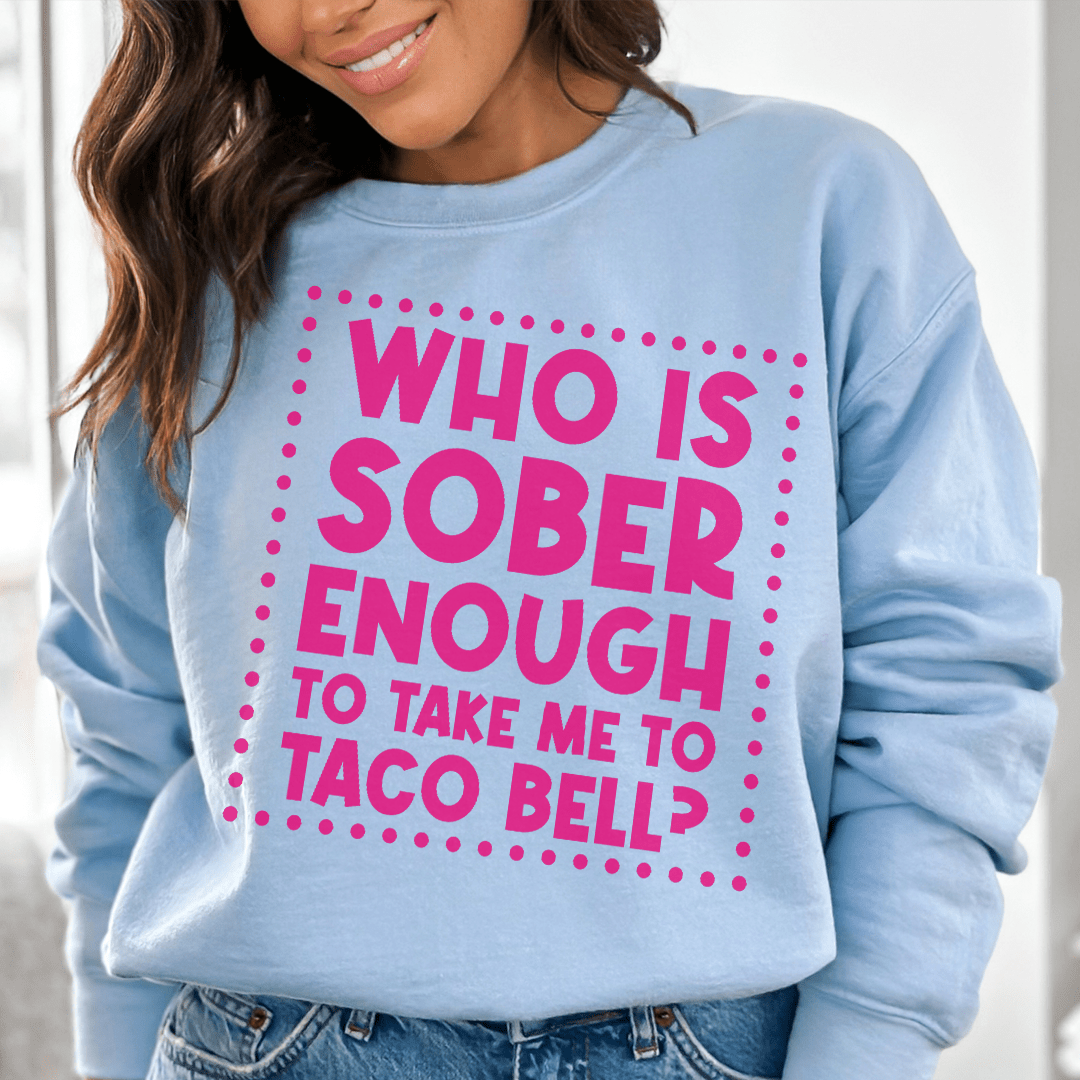 Woman wearing a light blue sweatshirt with the phrase &