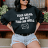 Model wearing a black sweatshirt with the text &